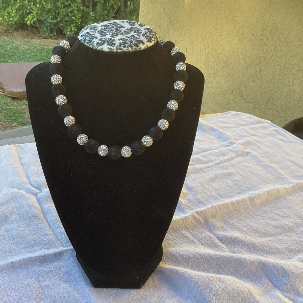 Close view of handmade crown necklace styled for Queen Worldwide Network