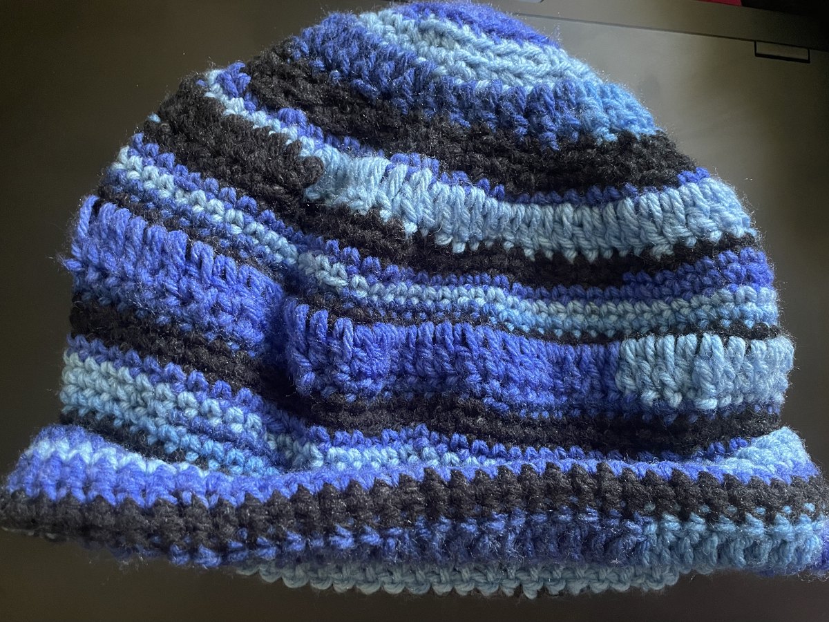 Black and blue handmade crochet hat styled for the winter crown collection