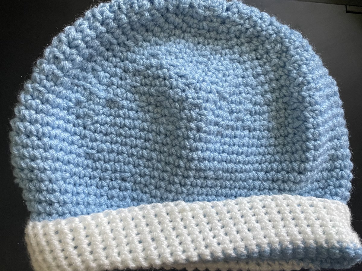 Light blue handmade crochet hat photographed for a product collection